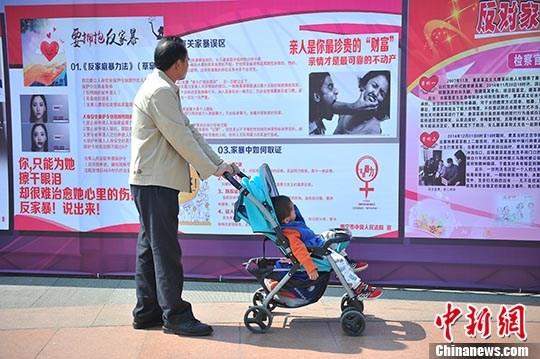 资料图:市民在广西南宁市民族广场观看反家暴资料。 <a target='_blank' data-cke-saved-href='/' href='/'>中新社</a>记者 胡雁 摄