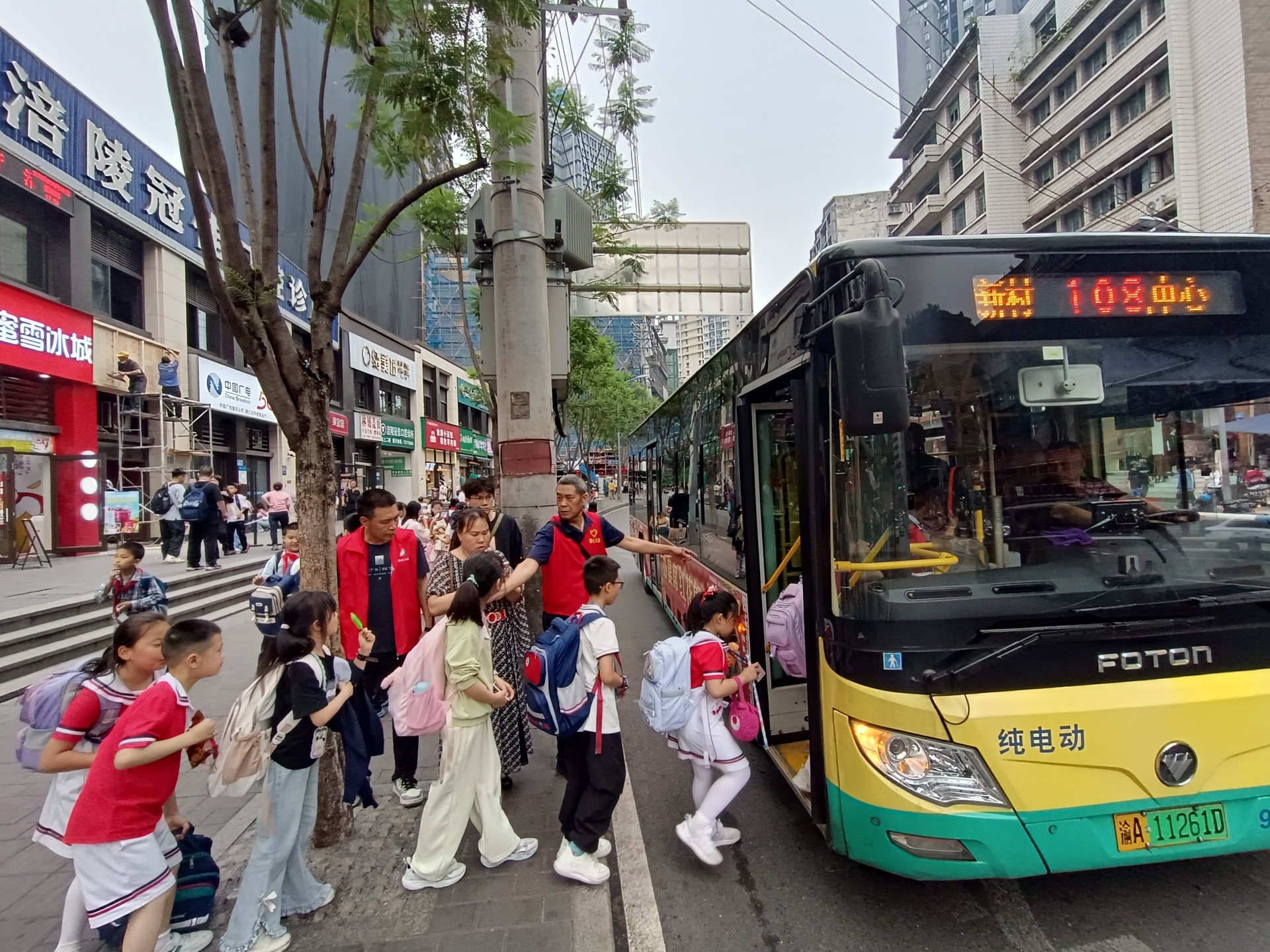 周晓明引导学生和市民有序安全乘车。图/重庆巿涪陵区融媒体中心记者 徐华东 f176612667f3f76abc1fda60d2e61c3a_.jpg