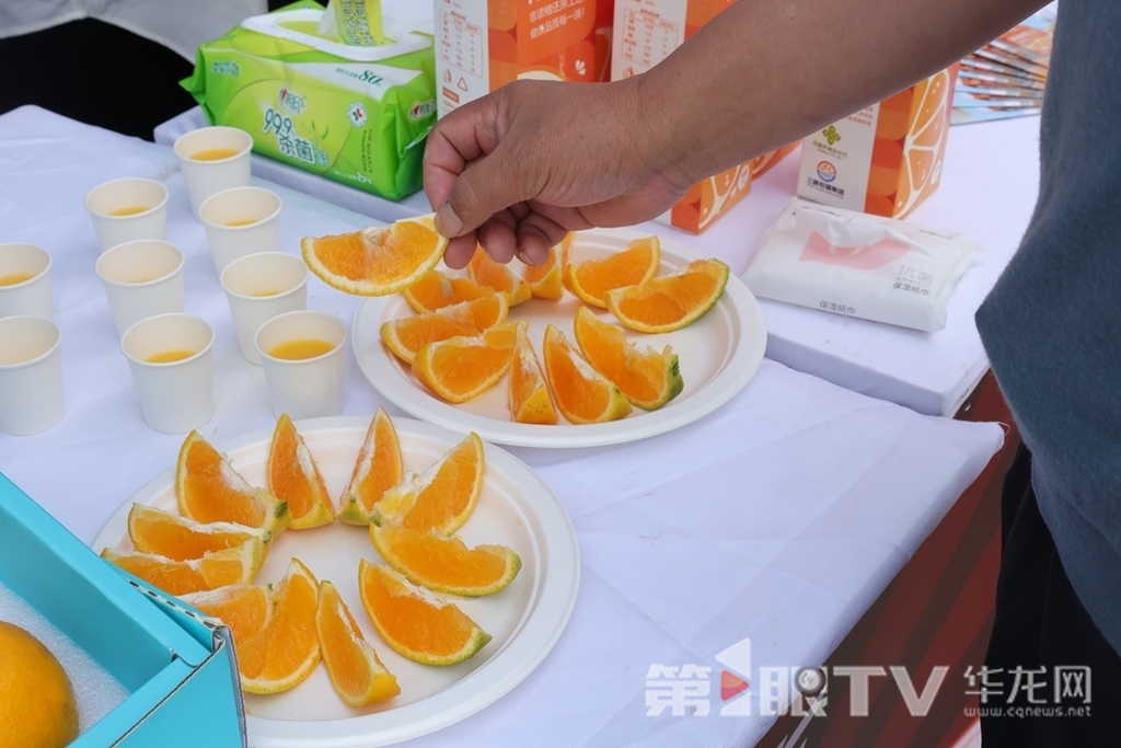 3 本地居民拿起橙子品尝。第1眼TV-华龙网 董静 摄
